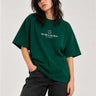 Camiseta boxy unisex de color verde oscuro con texto "THE TRIP IS THE TRUTH" y logo de LOCO MONKY