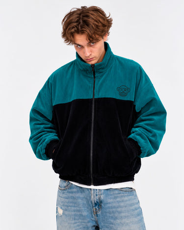 Chaqueta de pana oversize unisex en negro y azul océano, con logo de Loco Monky en el pecho.