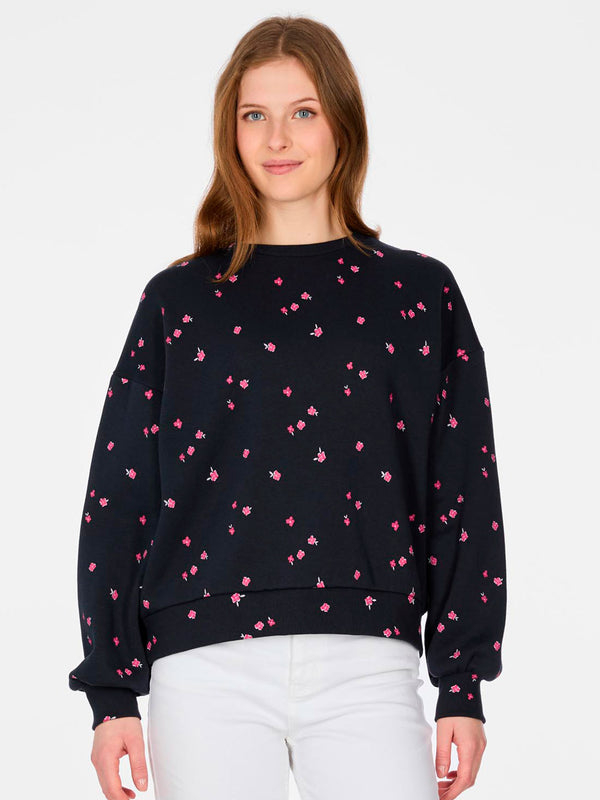Sudadera de mujer color navy con estampado de flores rosas, manga larga y corte amplio.