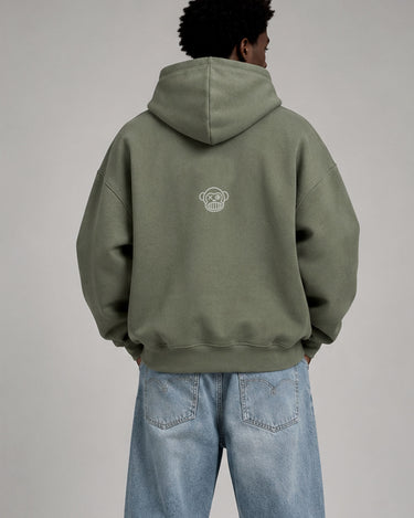 Sudadera boxy unisex en color oliva con capucha y logo de Loco Monky en la parte posterior.