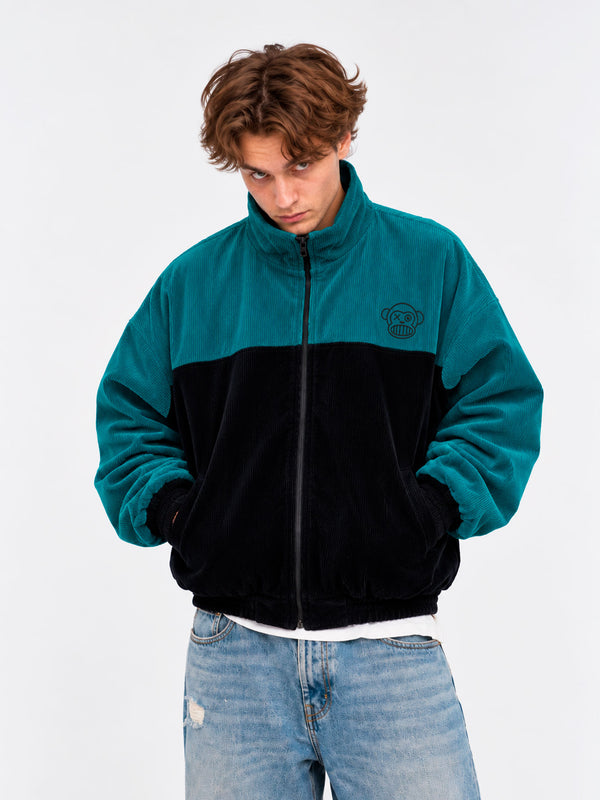 Chaqueta de pana oversize unisex en negro y azul océano, con logo de Loco Monky en el pecho.