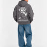 Sudadera unisex gris oscuro con diseño de mono en la espalda y texto 'THE TRIP IS THE TRUTH'.